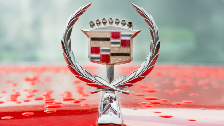a Cadillac hood emblem on a red hood